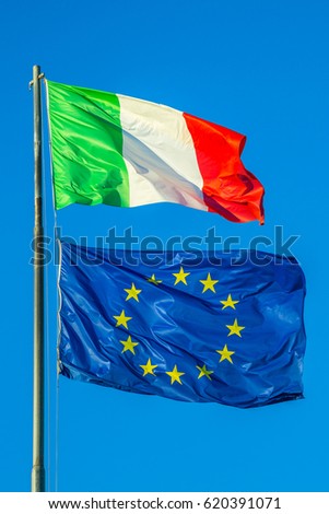 Italy flag and Europe flag waving together in isolated the blue sky background. Concept for financial treated, unique currency and financial bond.