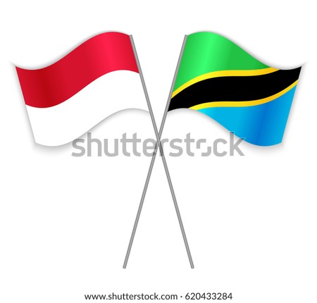 Monegasque and Tanzanian crossed flags. Monaco combined with Tanzania isolated on white. Language learning, international business or travel concept.