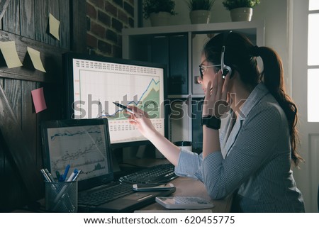 young girl operator helping customer analysis financial risk and using pen pointing the graphic. woman servicer wear suit sitting in office.
