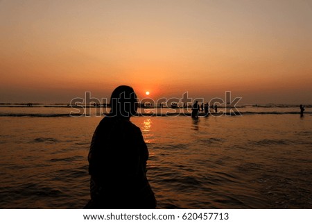 Woman silhouette during sunset on beach
