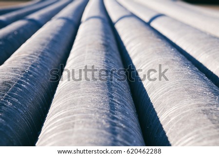 background of colorful big plastic pipes used at the building site close-up frontal view Royalty-Free Stock Photo #620462288