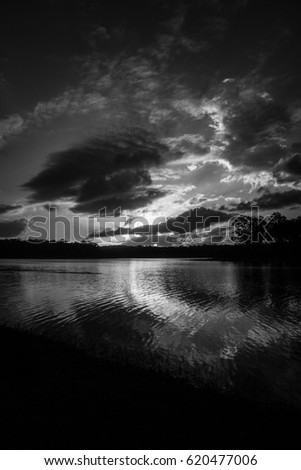 A black and white photograph of Lake Kurwongbah as the sun is setting. This photo was taken in Brisbane, Australia. 