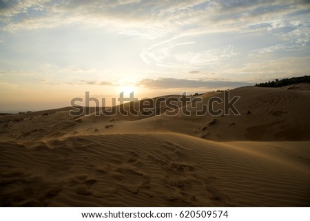 Red sand dune and blue sky in Mui Ne city, Vietnam. Royalty-Free Stock Photo #620509574