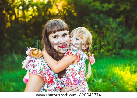 little girl on nature with the mother