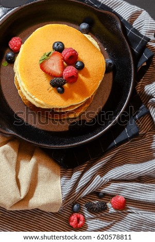 Fruits and pancakes in a pan