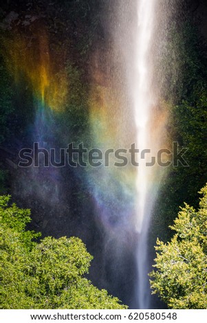 Rainbow created by the water of Phantom Waterfall dropping off over vertical basalt walls, North Table Mountain Ecological Reserve, Oroville, California