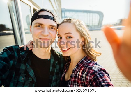 Lovely hipster couple taking selfie and having fun in summer time.