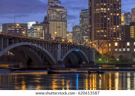 Close Up Twilight Shot of Minneapolis Skyscrapers and the Mississippi River's Lock and Dam System under the 3rd Ave Bridge