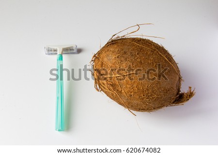 Abstract picture of epilation process - hairy coconut and razor