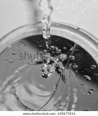 Water dripping from a bathroom faucet onto a cracked vanity mirror. This photo was taken in Brisbane, Australia. 