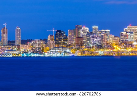 View of Seattle downtown with from Alki Beach at blue hour .