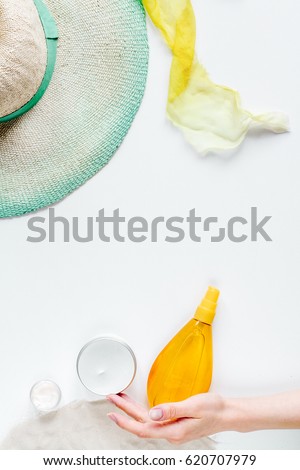 Cosmetic bottle with cream on white background top view mock up