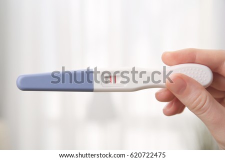 Pregnancy test in female hand on blurred background Royalty-Free Stock Photo #620722475
