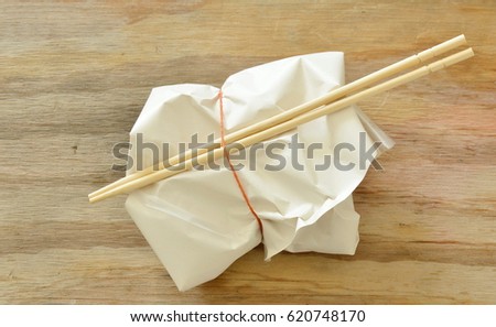  ready meal in paper packing by rubber band and wooden chopsticks
