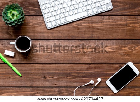 mans working place at wooden desktop with coffee