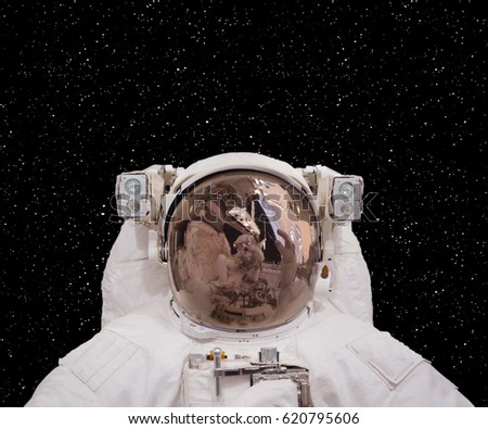 Astronaut posing against deep space and stars.  "The elements of this image furnished by NASA"
