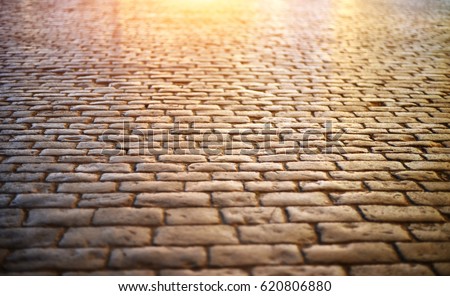 Paving stone vintage road cover. Evening road in a historical place. Royalty-Free Stock Photo #620806880