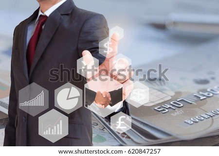 businessman with financial symbols and 
increase graph  from hand