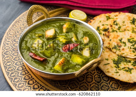Palak Paneer Curry made up of spinach and cottage cheese, Popular Indian healthy Lunch/Dinner food menu, served in a Karahi with Roti Or Chapati over moody background. selective focus Royalty-Free Stock Photo #620862110