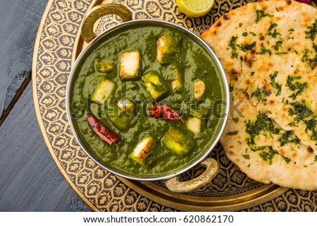 Palak Paneer Curry made up of spinach and cottage cheese, Popular Indian healthy Lunch/Dinner food menu, served in a Karahi with Roti Or Chapati over moody background. selective focus Royalty-Free Stock Photo #620862170