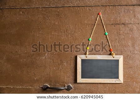 sign on a small chalkboard hanged to a wood door with pins