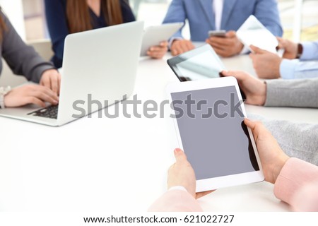 Team work concept. People sitting at table in office and using digital devices