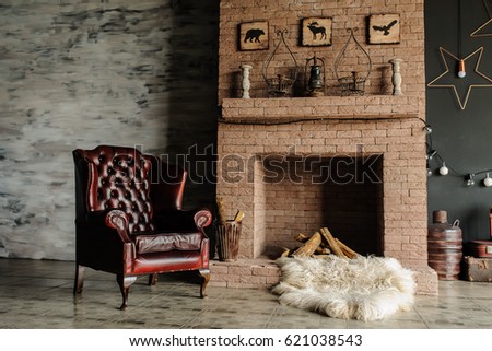 Vintage living room, retro style. Fur, leather armchair, fireplace, interesting bed with nice pillows and large windows