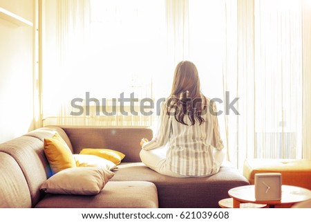 Young woman at home doing Yoga. Morning scene