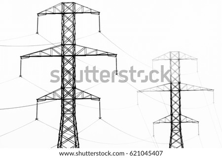High key black and white abstract of power line towers and fog.