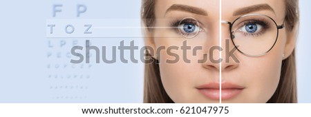 female face, cut in half to present before and after laser vision correction. Woman face with glasses and without glasses, on background virtual holographic eye chart. vision correction technology Royalty-Free Stock Photo #621047975
