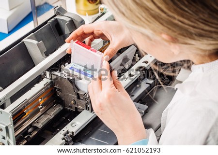 closeup shot young female technician repairing digital printer. Maintenance support and repairing sservice concept.
