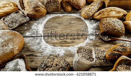 Various of baked bread on wooden table background. Place for typography