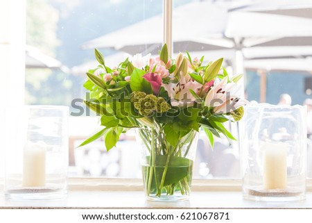 Floral decorations with different sorts of flowers, roses, tulips, and others