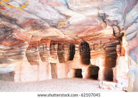 One of many amazing rainbow-coloured hollows of tombs and caves in ancient city of Petra, Jordan