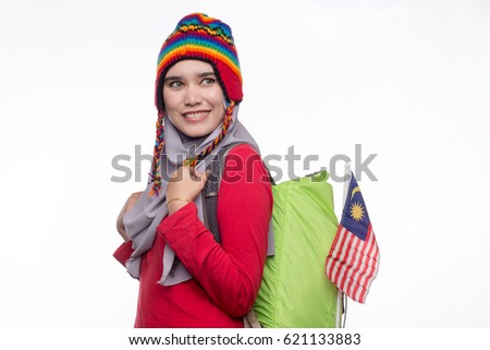 Close-up of a teenage muslim woman wearing a headgear, hijab and a backpack ready for hiking isolated on white background