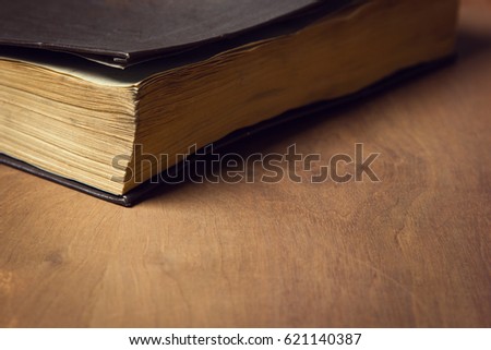 a very old book on a wooden table
