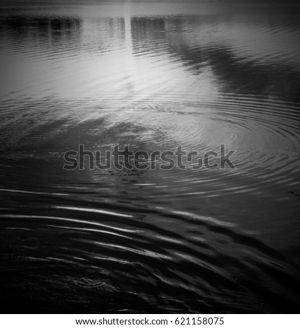 The rippled surface of a lake in black and white. This photo was taken at the Kurwongbah Dam in Brisbane, Australia. 
