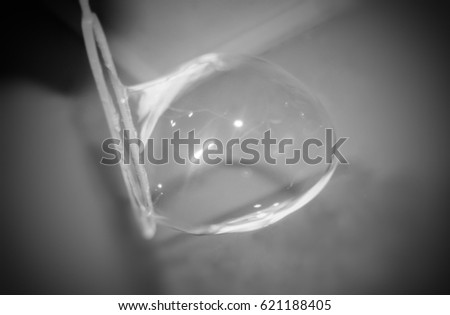 A black and white, artistically manipulated photograph of a bubble being blown in Brisbane, Australia. 