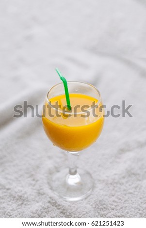 Pineapple, orange juice in a glass with a straw, juice for healthy nutrition.