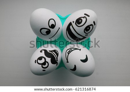 Eggs with a cute face. Photo for your design. Four eggs lie and look up. Concept: flirt