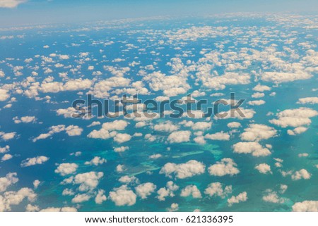 Aerial view of turquoise eastern coast of Florida. Beautiful white clouds over the Atlantic, turquoise sea with clouds. USA
