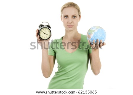 Young woman holding a wake up alarm and the Earth; concepts: time to wake up, time to protect the Earth