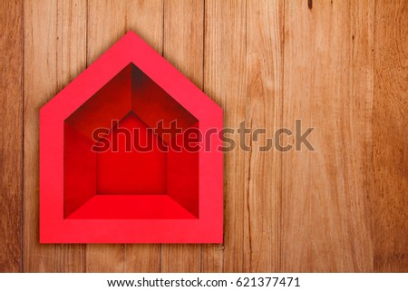 red house papercut shape on old plank wooden floor with free copyspace