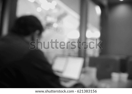 Picture blurred  for background abstract and can be illustration to article of Business man working laptop in coffee shop