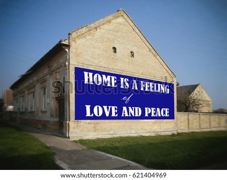  Home is a feeling of love and peace.The village, old house.  Motivation, poster, quote, blurred image, blue background, white letters.                                      