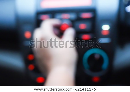 Picture blurred  for background abstract of Hand tuning fm radio button in car panel