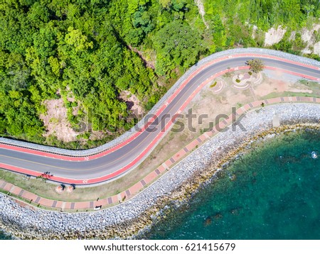 Aerial view from drone of coastal road with bike lane to Nang Phaya Hill Scenic Point in Chanthaburi, Thailand