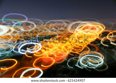 Colorful abstract glowing twirl lines at night.