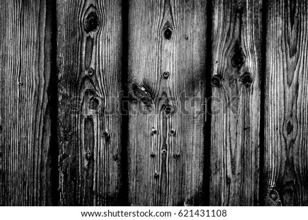 Old plank wooden wall background. The texture of old wood. Weathered piece of wood. Image includes a effect the black and white tones.