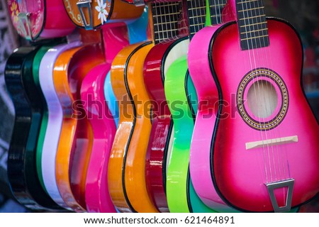 Colorful Ukuleles presented for sale on a market Royalty-Free Stock Photo #621464891
